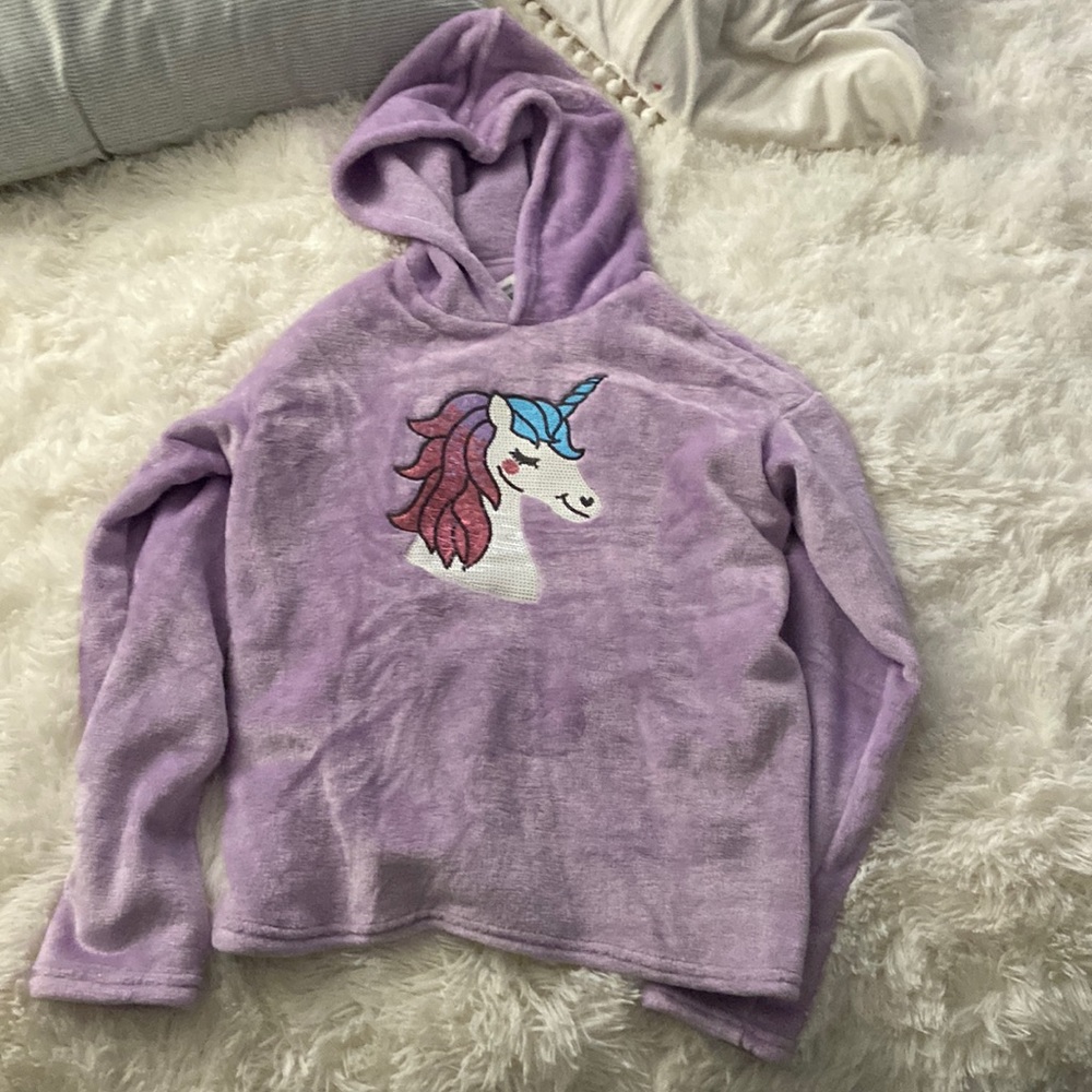 Purple sweater with unicorn sequence